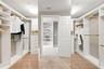 Primary bedroom walk in closet