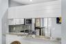 The kitchen pass-through offers the perfect spot for a buffet, making entertaining effortless.