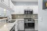 The light filled kitchen features stainless steel appliances and granite countertops.