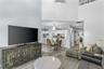 The two-story shiplap feature wall adds architectural interest and a warm focal point in the living room.