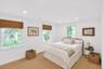 Recessed lighting, wood-finish flooring, and multiple double-hung windows with woven wood shades