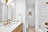 Modern vanity featuring an integrated rectangular sink and gold-tone fixtures