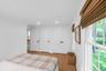 Recessed lighting, wood-finish flooring, multiple windows, window treatments, and white interior doors