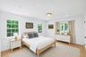 Wood-finish flooring, recessed lighting, and a circular flush-mount ceiling fixture
