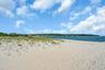 Sandy beach with natural dune grass and waterfront access