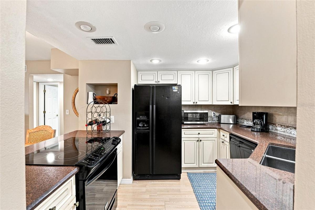 Kitchen with stainless refrigerator