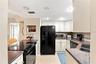 Kitchen with stainless refrigerator