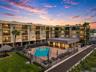Building exterior at dusk with pool