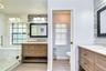 Features dual vanities and a beautiful seamless glass shower