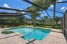 Spacious covered and screened outdoor living area overlooking the pool