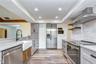 Open kitchen featuring stainless steel appliances, abundant cabinetry, and generous counter space