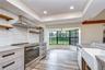 Bright casual dining area surrounded by charming bay windows