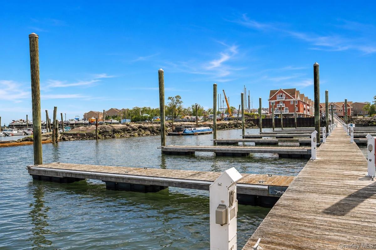 Wooden dock with multiple boat slips and pilings