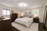 Primary bedroom virtually staged w/en suite bathroom