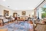 Hardwood flooring, recessed lighting, crown molding, and large windows
