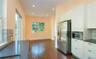 Kitchen featuring dark countertops, appliances with stainless steel finishes, white cabinets, dark wood-style floors, and recessed lighting