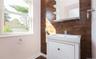 Bathroom featuring vanity and wooden walls