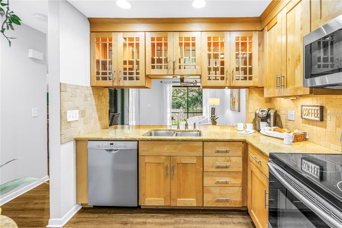 Great Kitchen workspace with glass cabinets for Natural light.  Granite Counters and stainless appliances