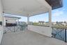 Fourth-level private patio with an inviting outdoor seating area and expansive, seemingly endless water views.