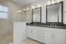 Third-level primary en-suite featuring double sinks and a spacious walk-in shower.