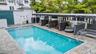 Crystal-blue community pool with plenty of inviting spaces to relax and unwind.