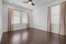 Third-level third bedroom featuring east- and south-facing windows for abundant natural light.