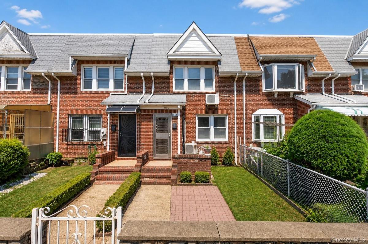 Brick facade with a gabled roofline and bay windows