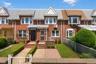 Brick facade with a gabled roofline and bay windows
