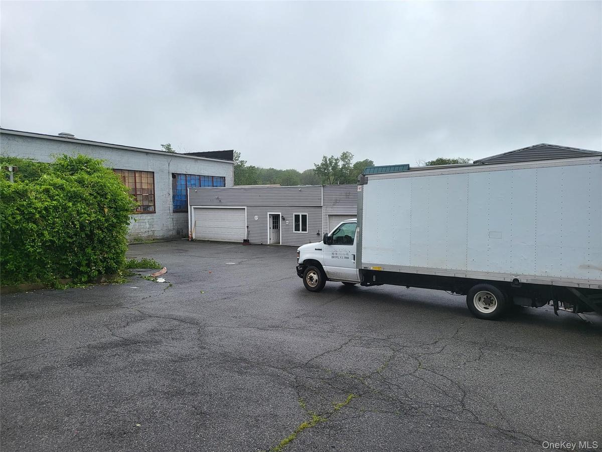 View of parking featuring a garage