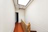 Recessed ceiling light with decorative trim, wood-finish flooring, and a classic wood banister