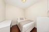 Warm neutral wall color, dark wood-finish flooring, and a flush mount ceiling light fixture