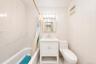 White subway tile surround with accenting patterned tile