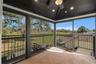 Screened lanai off of primary bedroom overlooking golf course