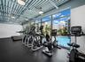 Well equipped fitness center overlooking pool
