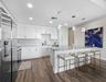 Luxury vinyl flooring & exquisite tile backsplash. Upgraded light fixtures over roomy breakfast bar