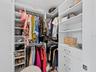California closet system in main bedroom walk in closet
