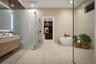 Spa inspiring primary suite bathroom with glass panel shower