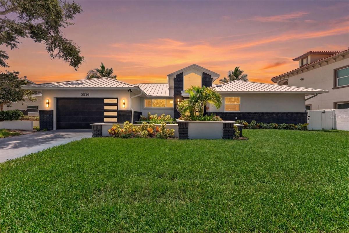 Front elevation of the home at twilight, showcasing its curb appeal and inviting ambiance.