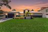 Front elevation of the home at twilight, showcasing its curb appeal and inviting ambiance.