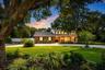 Refreshed landscaping, mature trees, and drip irrigation create a beautiful park-like setting