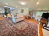 Hardwood flooring throughout, recessed lighting, skylight, and an open stairway with wrought iron balusters
