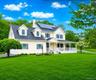 Inviting Colonial with wrap-around front Porch at the end of a cul-de-sac on over an acre