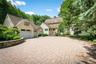 Large driveway, designed with pavers, Belgium block edging and stone wall.