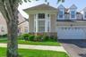 Exterior Street view featuring bay windows, stone facade accents,  and a newly paved driveway