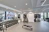 Fitness center featuring extensive mirrored walls, recessed lighting, and large windows