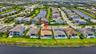Waterfront property featuring a private swimming pool, covered patio, and established landscaping