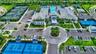 Expansive recreation complex featuring multiple tennis courts, a basketball court, two swimming pools, and extensive parking areas