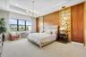 Expansive room featuring a tray ceiling, recessed lighting, and a large multi-pane window