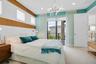 Bedroom featuring a light-colored carpet, a full-height glass sliding door opening to an outdoor balcony, and a contemporary ceiling fixture