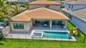Outdoor living space featuring a rectangular swimming pool, integrated spa, and expansive patio area
